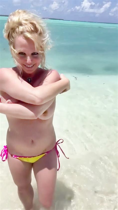 britney spears flashes her nude tits as she poses topless on the beach 14 enhanced pics video