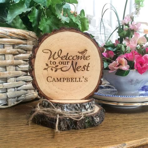 A Wooden Sign That Says Welcome To Our Nest Campbells Sitting On A Table