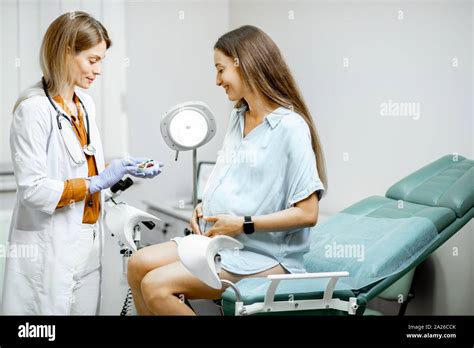 Gynecologist Giving Some Medicine For A Young Pregnant Woman During A Medical Examination In The