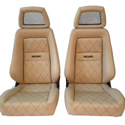 two tan leather seats with black stitching on the front and back side one is facing