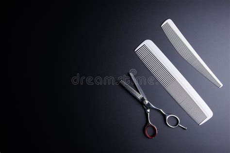 Stylish Professional Barber Scissors And White Comb On Black Background