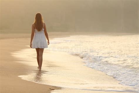 Woman Walking On The Sand Of The Beach Stock Photo Image