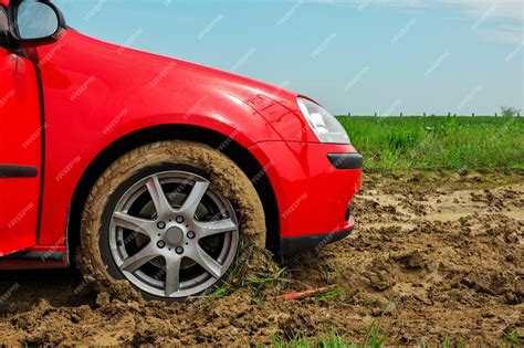 Premium Photo The Red Car Stuck In The Mud Can Not Fall Out Of The Mud
