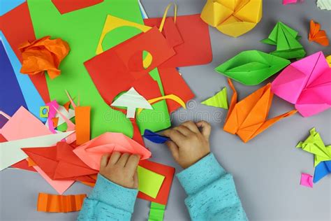 Child Makes Origami Crafts From Colored Paper Stock Image Image Of