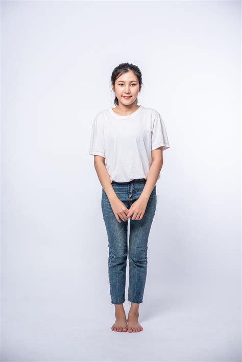 Girl In White Stretch Jeans And Standing Straight On White Background
