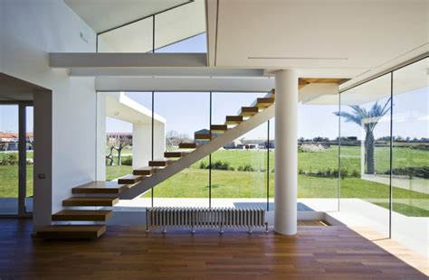 Crates and baskets keep shoes organized beneath a small console table. 12 Excellent Examples Of Stairs Without Railings | CONTEMPORIST