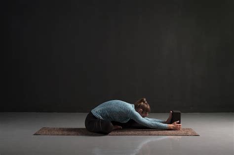 Premium Photo Woman Doing Yoga Training Sitting In Janu Sirsasana