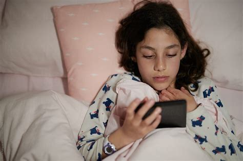 girl with kindle in bed by stocksy contributor guille faingold stocksy