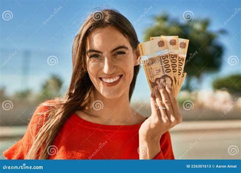 Young Hispanic Woman Smiling Happy Holding Hungarian Forint Banknotes