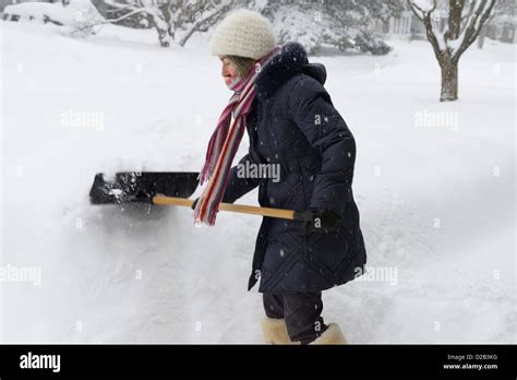 Woman Shoveling Deep Snow After A Winter Storm In Ottawa Canada Stock