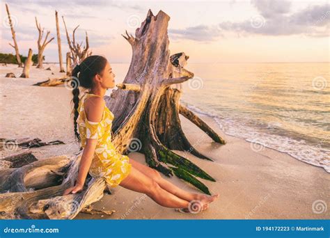 Beautiful Sunset Paradise Woman Relaxing On Sun Summer Beach Holiday Outdoor Sitting Watching