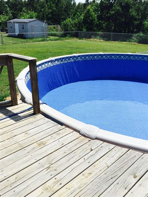 Place it on the top rail of one end of the swimming pool, with one end hanging over the outside of the pool by about 1 foot. How to Install a Base For Your Above Ground Pool Liner