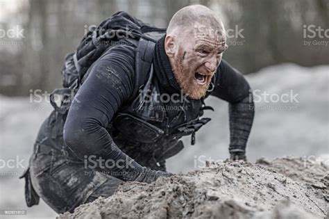Redhead Shaved Male Military Member Training Hard On A Sand Hill Run