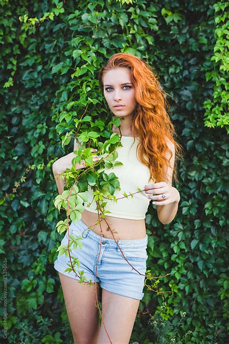 Beautiful Young Redhead On A Green Ivy Wall By Giorgio Magini Nature