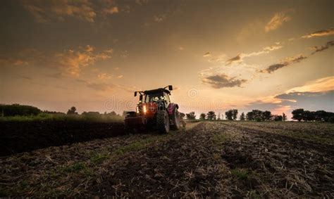 Tractor On The Field During Sunset Stock Photo Image Of Machine