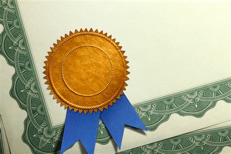 Gold Seal With Blue Ribbon On A Certificate Of Achievement Stock Photo