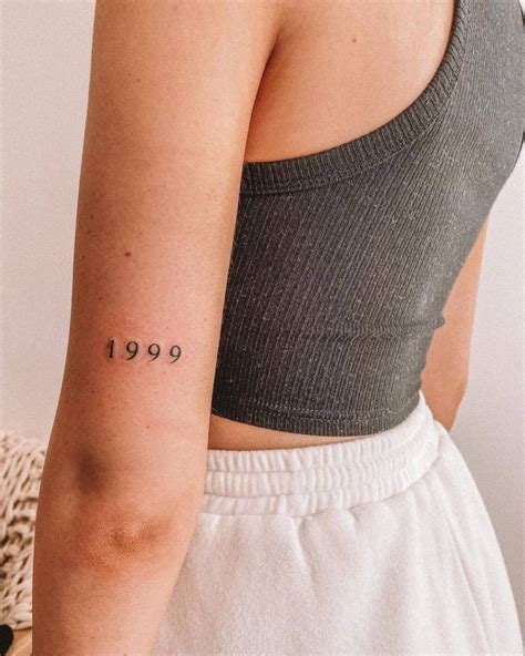 1999 Lettering Tattoo On The Tricep