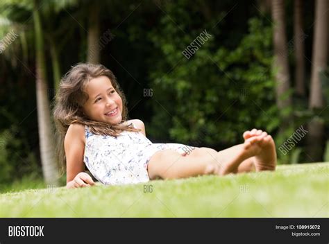 Smiling Little Girl Lying On Green Image And Photo Bigstock