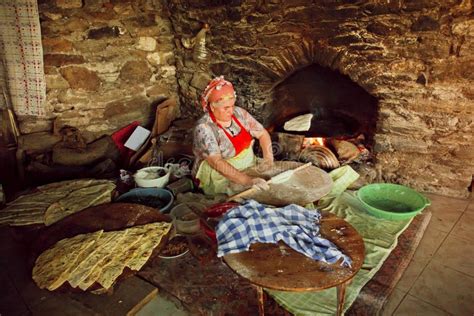elderly woman cooking traditional gozleme dish rustic stone oven of old turkish village
