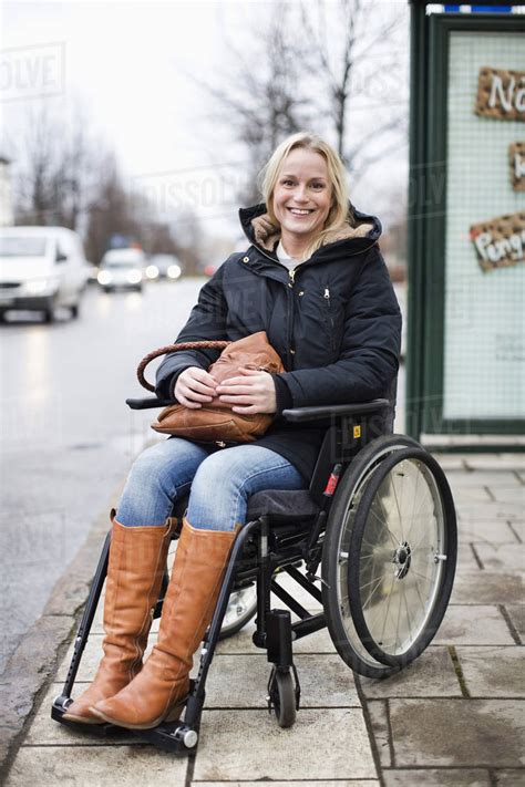 Portrait Of Happy Disabled Woman In Wheelchair Smiling Outdoors Stock