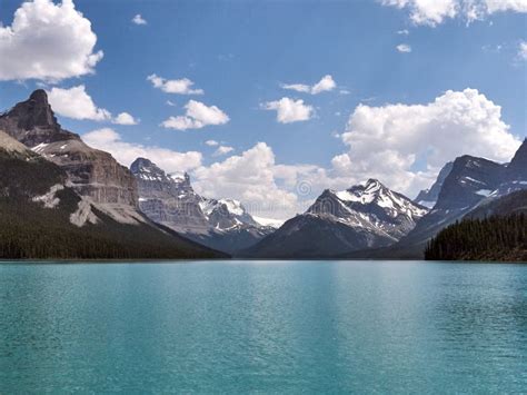 Rocky Mountains Surrounding Beautiful Calm Turquoise Lake Stock Image