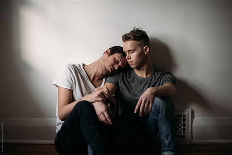 Young Gay Male Couple In Love Sitting On Bedroom Floor By Stocksy