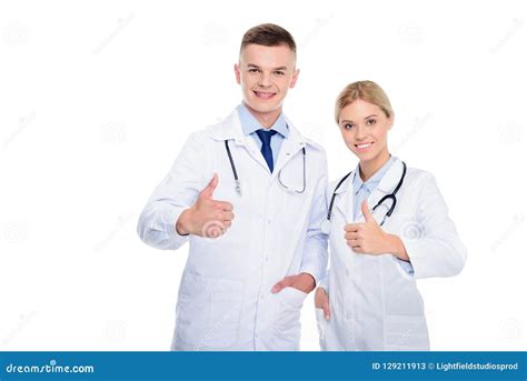 Male And Female Doctors In White Coats With Stethoscopes And Thumbs Up