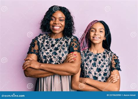 Beautiful African American Mother And Daughter Wearing Party Dress Happy Face Smiling With