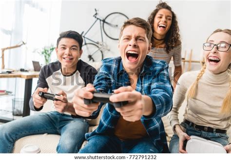 Laughing Multicultural Teens Playing Video Game Stock Photo Edit Now