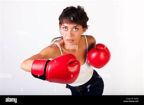 Young Beautiful Woman Punching Towards Camera Wearing Boxing Gloves On