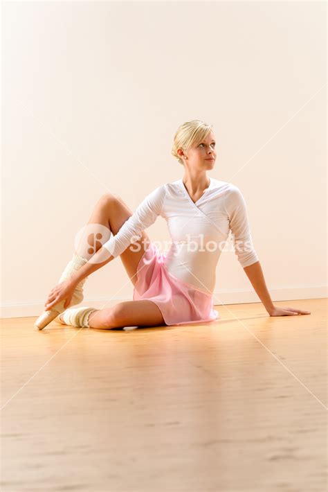 Beautiful Ballerina Sitting On Floor Holding Ankle Woman Ballet Exercise Royalty Free Stock