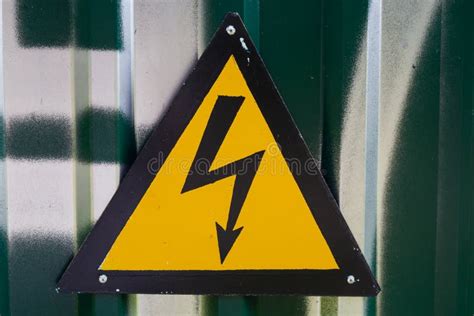Sign Of Danger Lightning On A Green Metallic Background Stock Photo