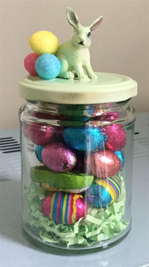 A Glass Jar Filled With Colorful Easter Eggs