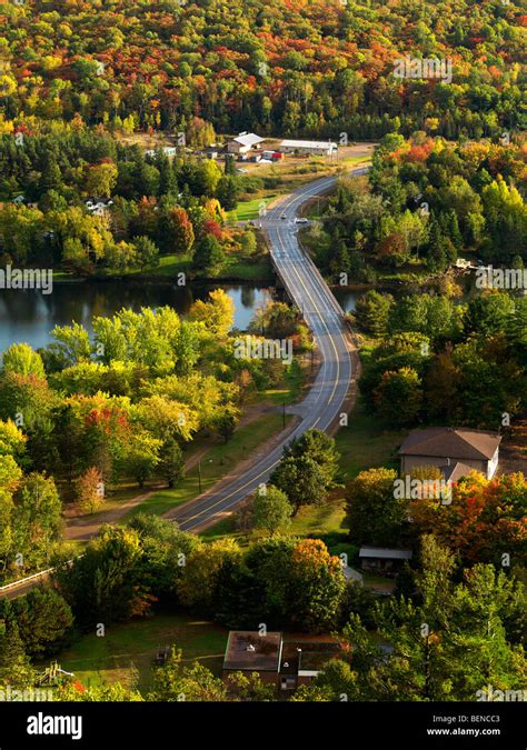 Aerial Fall Nature Scenery Of A Winding Road Crossing The Lake Of Bays