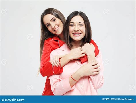 two beautiful girls dressed in pajamas hugging and smiling stock image image of girls couple