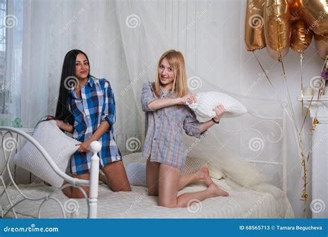 Duas Meninas Que Sentam A Luta De Descanso Na Cama Imagem De Stock Imagem De Feliz Alegria