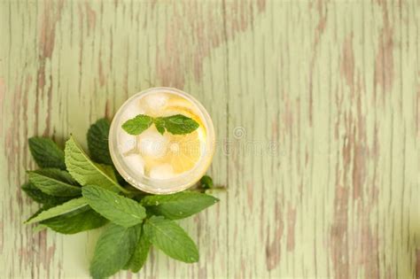 Refreshing Summer Drink With Fresh Lemon Slices And Mint Leaves On A