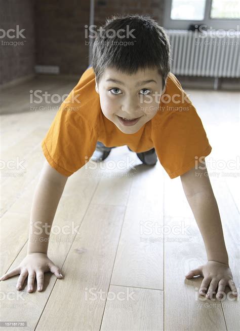 Smiling Boy Doing Pushups Indoors Stock Photo Download Image Now