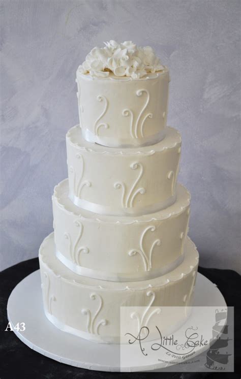 A43 Elegant Buttercream Wedding Cake With White Bands And Floral Design