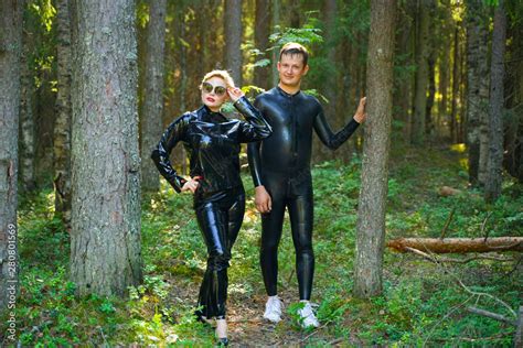 Beautiful Loving Couple Posing In Latex Rubber Fetish Costumes Outside