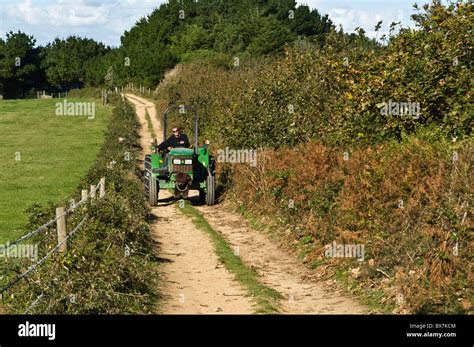 Dh Herm Island Herm Guernsey Herm Farmer Driving Tractor Along Country