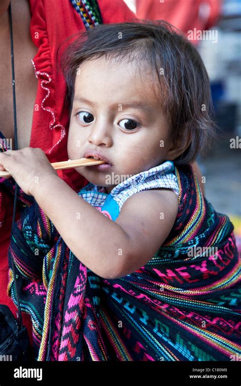 Wide Eyed Indigenous Mexican Baby Girl Wrapped In Beautiful Oaxacan