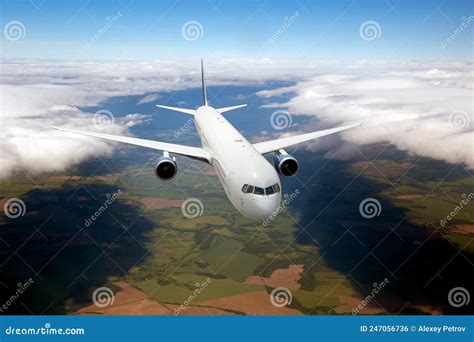 Passenger Plane In Flight Aircraft Fly High In The Sky Over Green