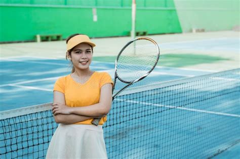 Female Tennis Player Smiling At Camera With Crossed Hands Stock Image