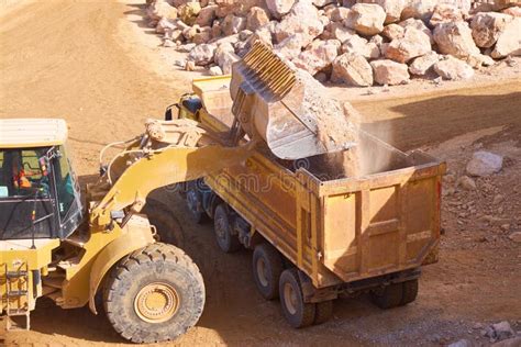 Front Loader Loads Rock Into A Dump Truck Stock Image Image Of