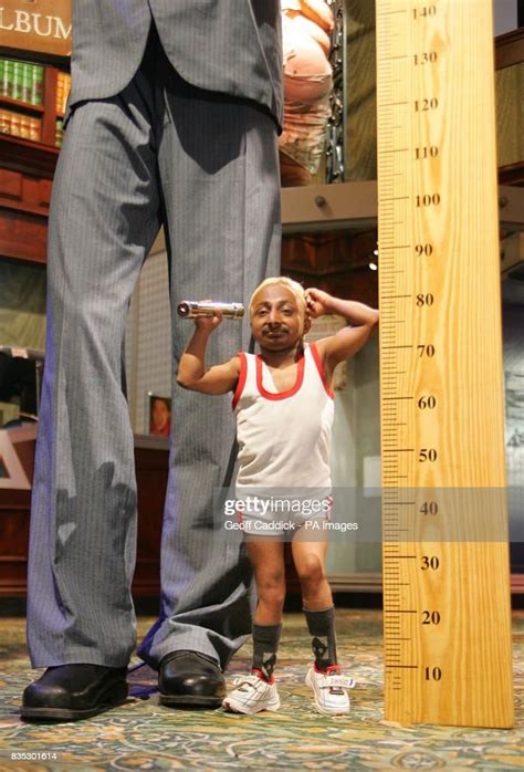 Romeo Dev The Worlds Smallest Bodybuilder Stands Next To A Model Of