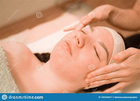 Beautiful Young Woman Getting A Face Massage Treatment At Beauty Salon Stock Image Image Of