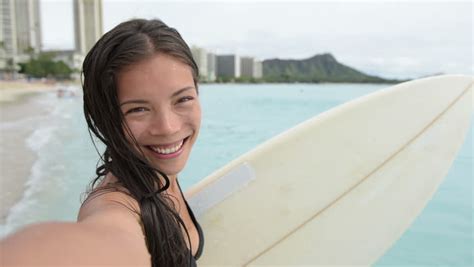 Surfing Surfer Girl Taking Selfie Photograph Holding Surfboard On Beach