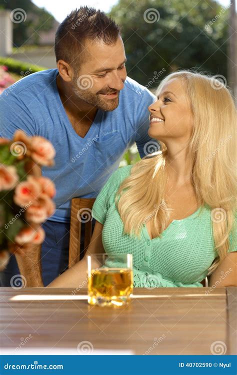 Portrait Of Romantic Couple On Rooftop Terrace With City Skyline In
