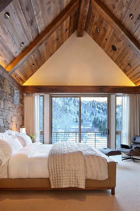 Gabled roof and wall of glass gives the home a comfy bedroom with headboard wall in wood. How to Create the Perfect Modern Rustic Bedroom